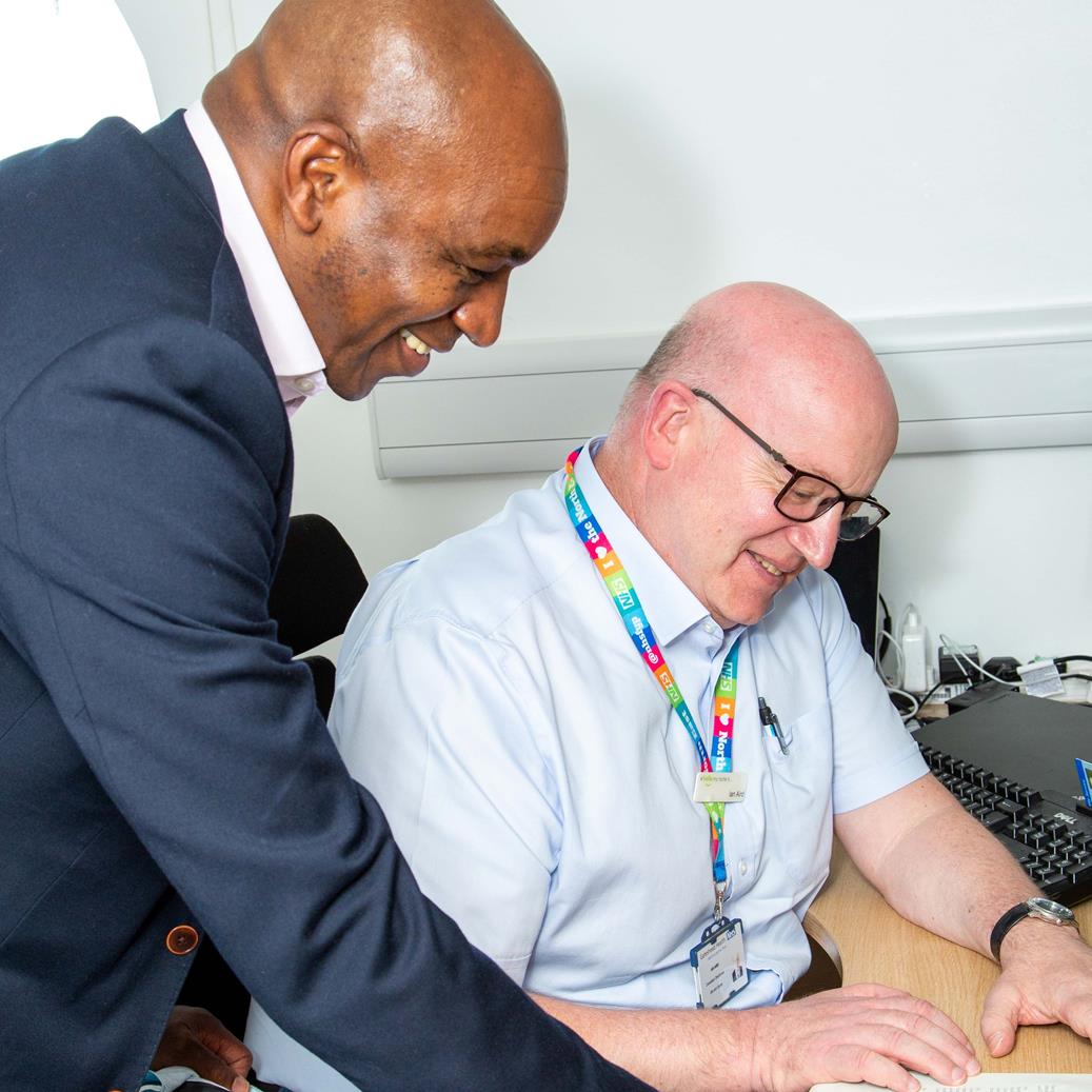 Gateshead Fertility: Two consultant doctors read a document on a table. 